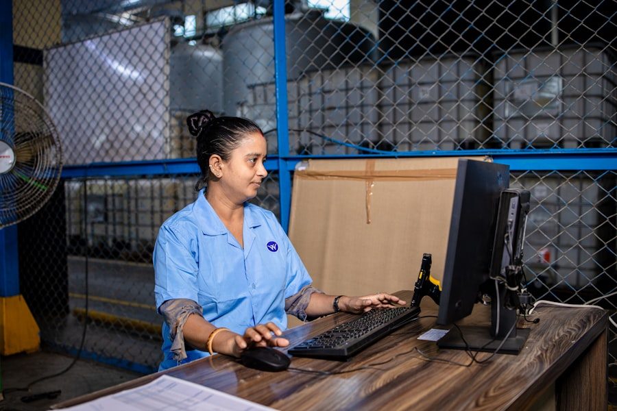 Warehouse staff member managing online orders at a computer