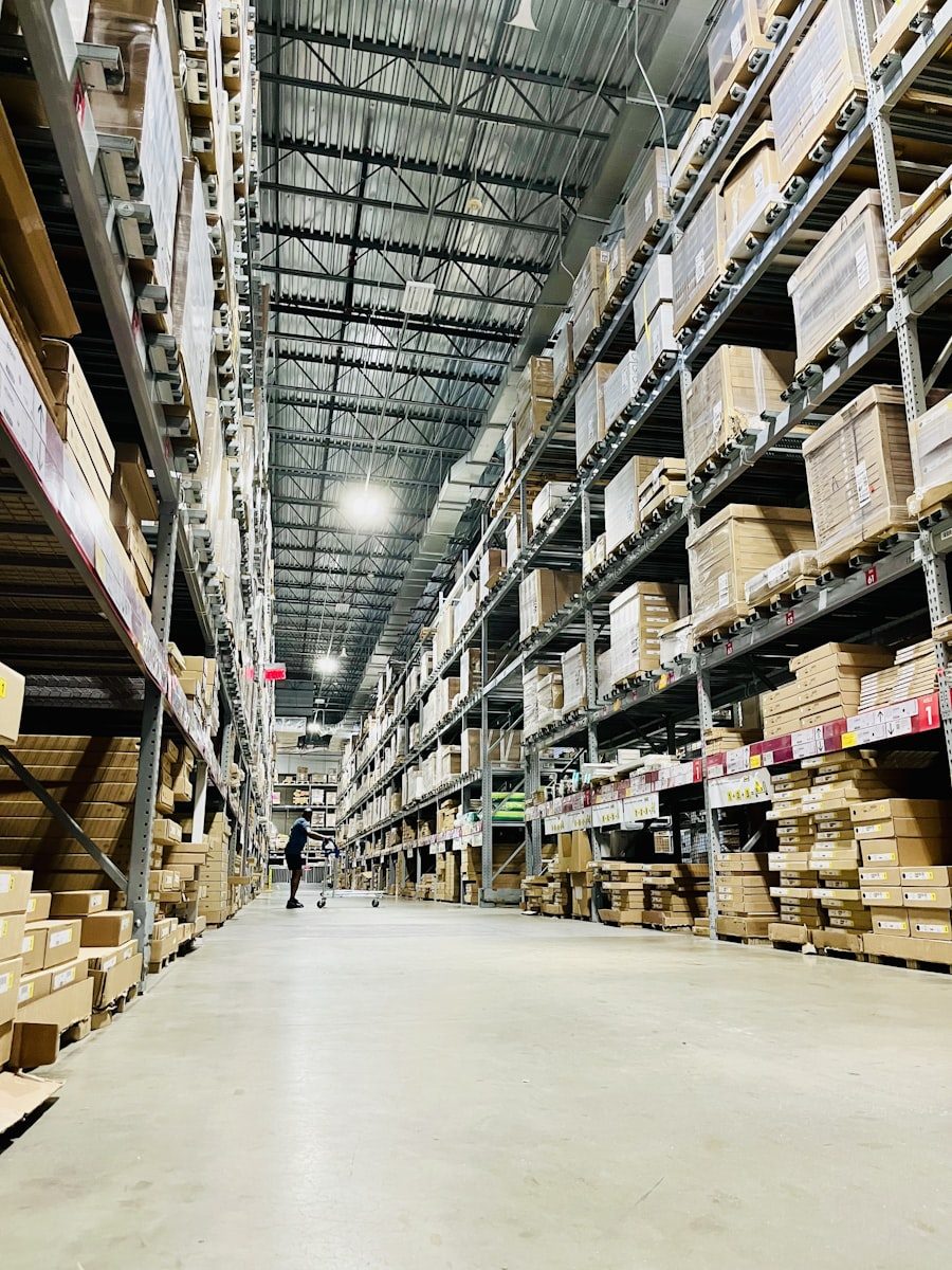 Tall warehouse aisle stocked with shelves of boxed goods