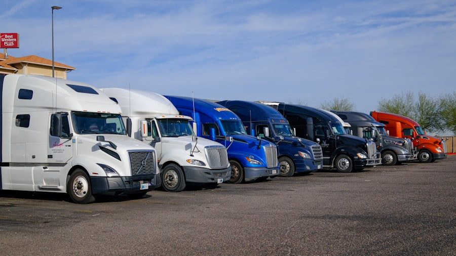 Row of different sized freight trucks parked side by side