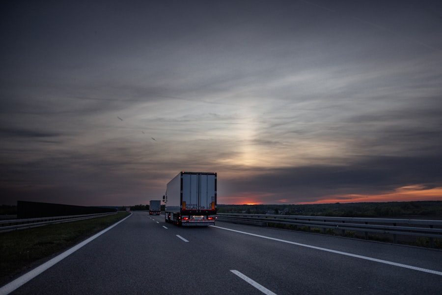 Freight truck driving on a highway at sunset